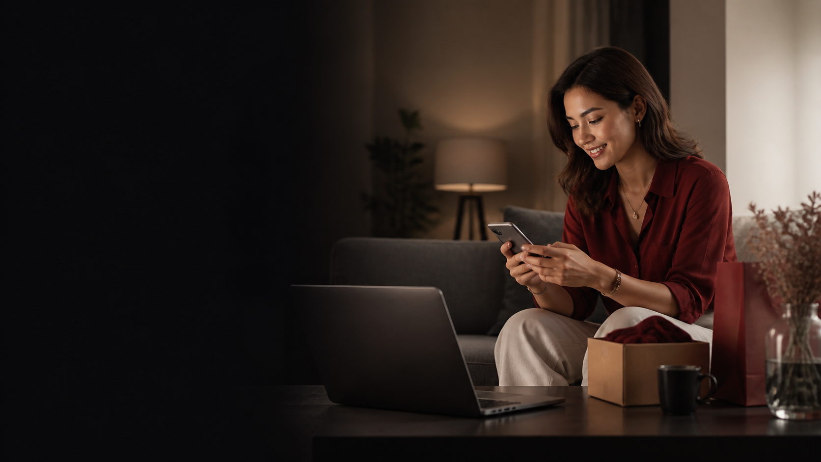 A customer completing an online purchase at home using a phone and laptop